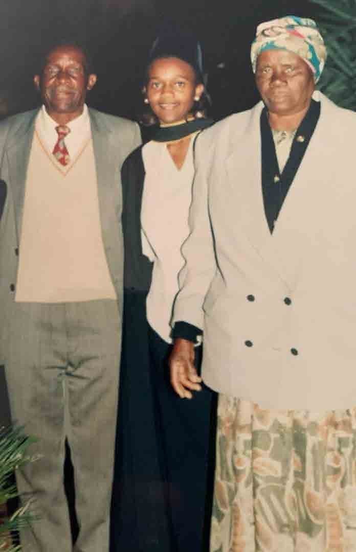 Graduation day portrait with Clara and two family elders.