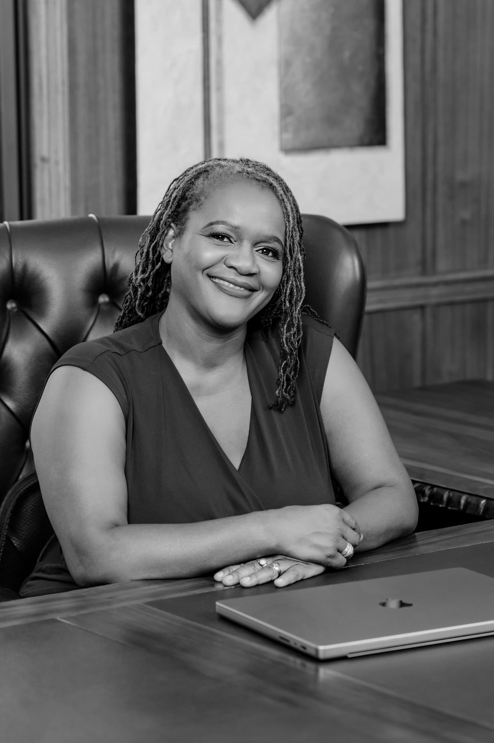 Clara Mlambo seated at an office desk with a laptop.
