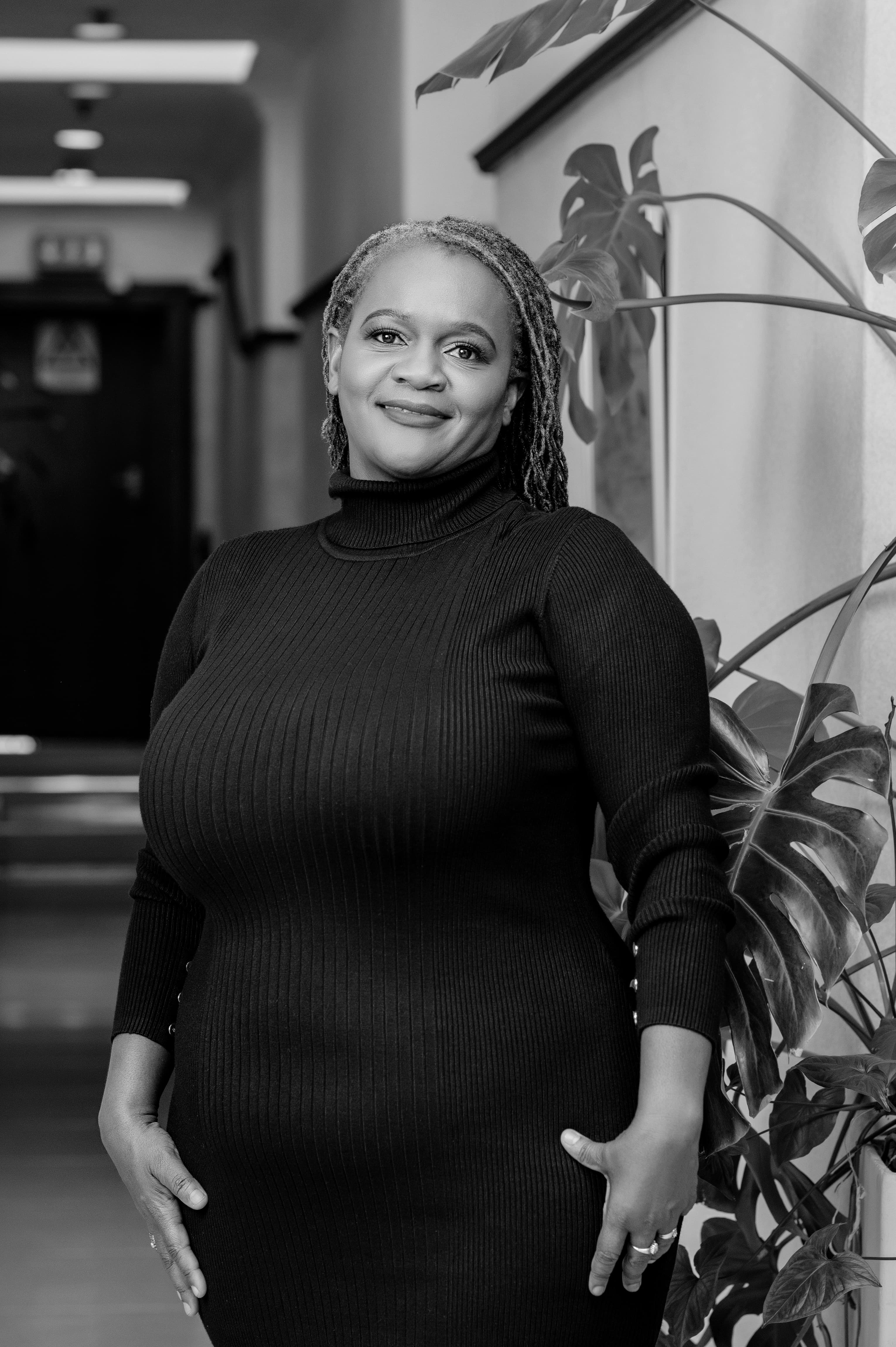 Clara Mlambo in a black-and-white office portrait.